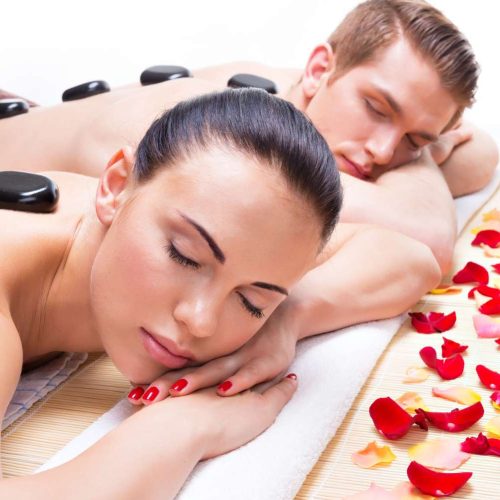 portrait-attractive-couple-relaxing-spa-salon-with-hot-stones-body