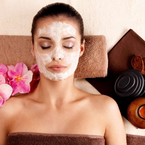 young-woman-relaxing-with-cosmetic-mask-face-beauty-salon-indoors